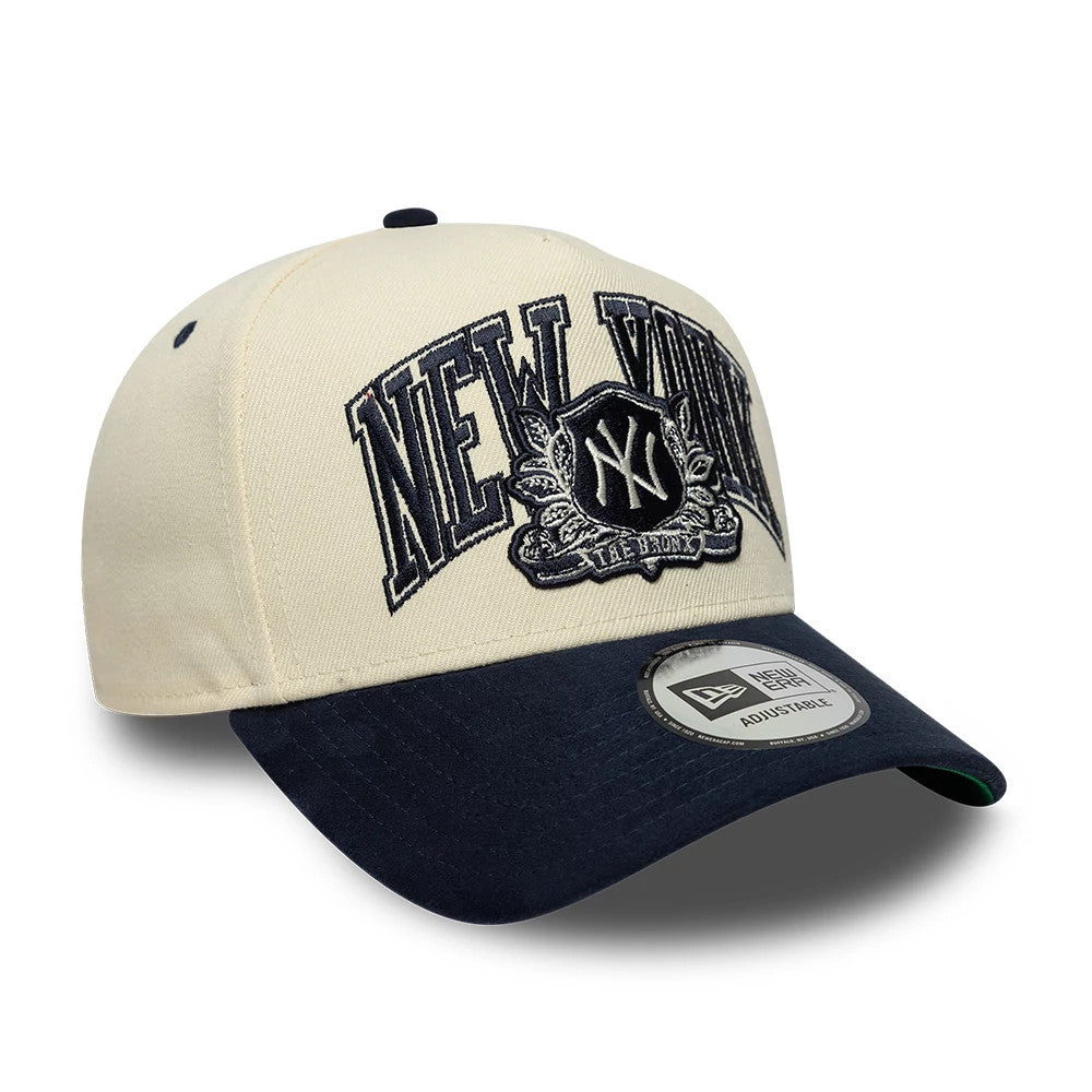 New York Yankees MLB Suede Cream & Navy New Era 9FORTY E-Frame Adjustable Cap, three-quarter view showing raised navy embroidery of New York and Yankees crest on front cream panels, navy curved visor with 9FORTY size sticker.