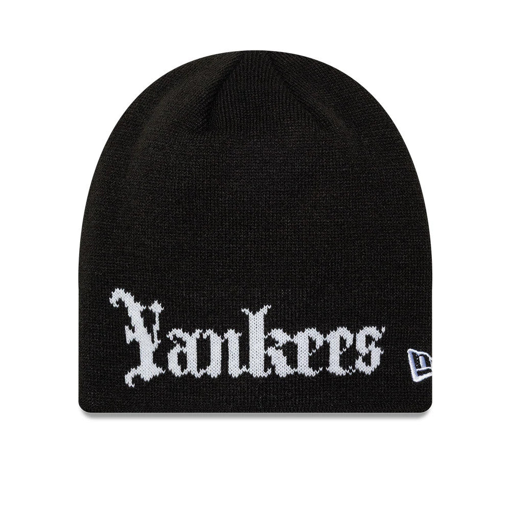 New Era New York Yankees MLB Script Black Skull Knit Beanie Hat, front view showing the white Yankees script embroidered prominently across the front with a gothic font, complemented by the New Era flag logo on the right side.
