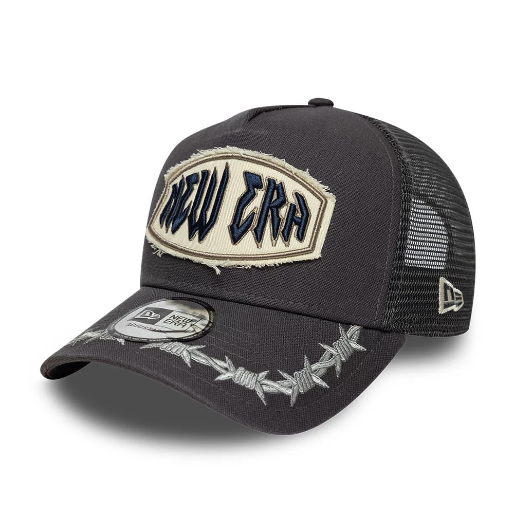 Pictured is this New Era Distressed Patch 9FORTY E-Frame Trucker cap in charcoal. 1