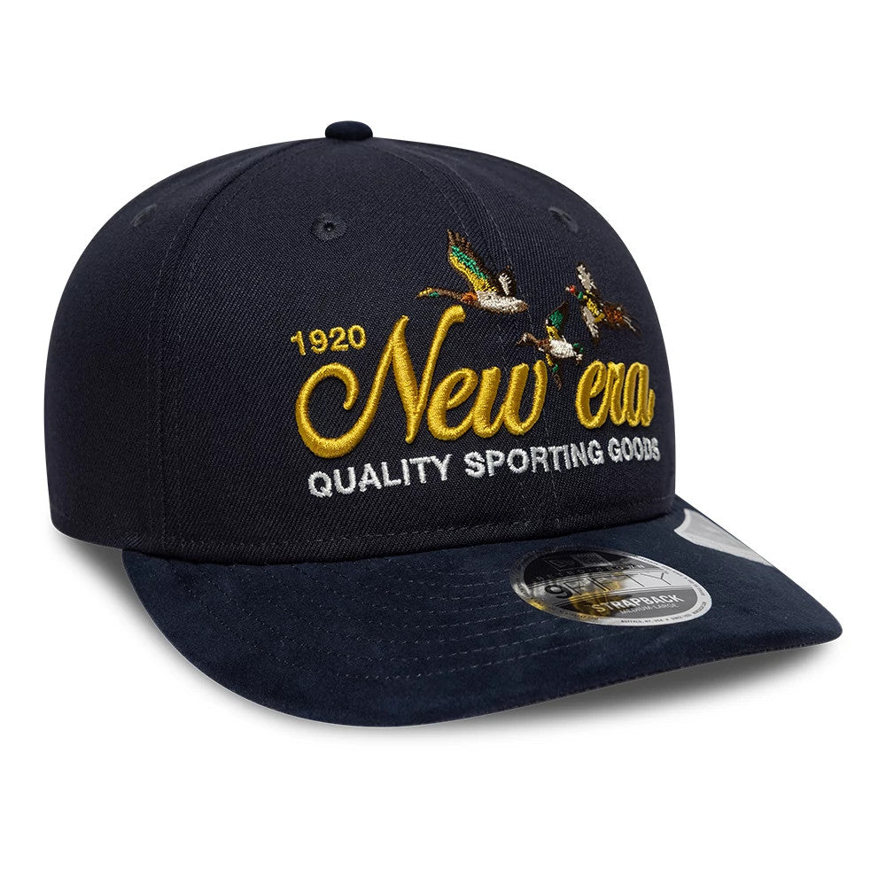 New Era Suede Navy Retro Crown New Era 9FIFTY Adjustable Cap, front view showing yellow New Era script and Quality Sporting Goods text with bird embroidery on the structured crown, and a navy suede curved visor with a 9FIFTY size sticker.
