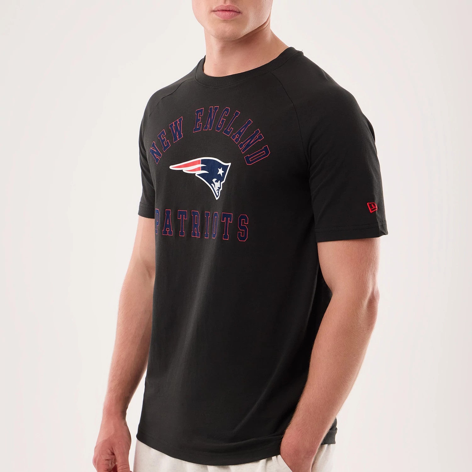 The model is wearing this NFL Sideline 2026 New England Patriots T-Shirt in black. 3