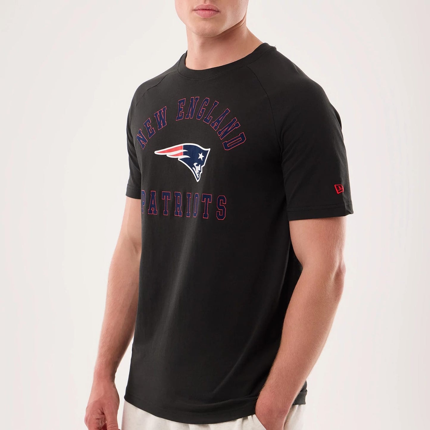 The model is wearing this NFL Sideline 2026 New England Patriots T-Shirt in black. 3