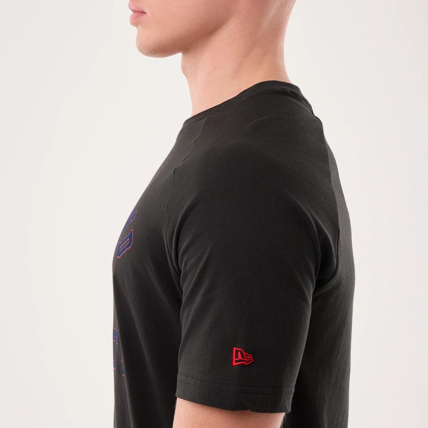 The model is wearing this NFL Sideline 2026 New England Patriots T-Shirt in black. 5