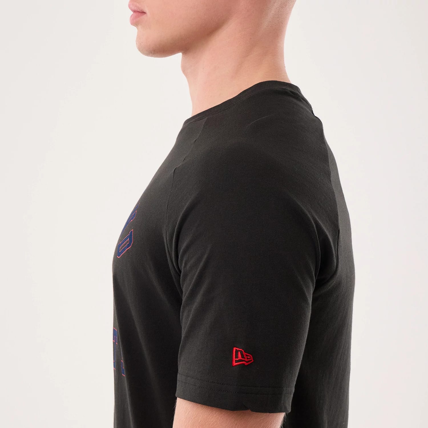 The model is wearing this NFL Sideline 2026 New England Patriots T-Shirt in black. 5