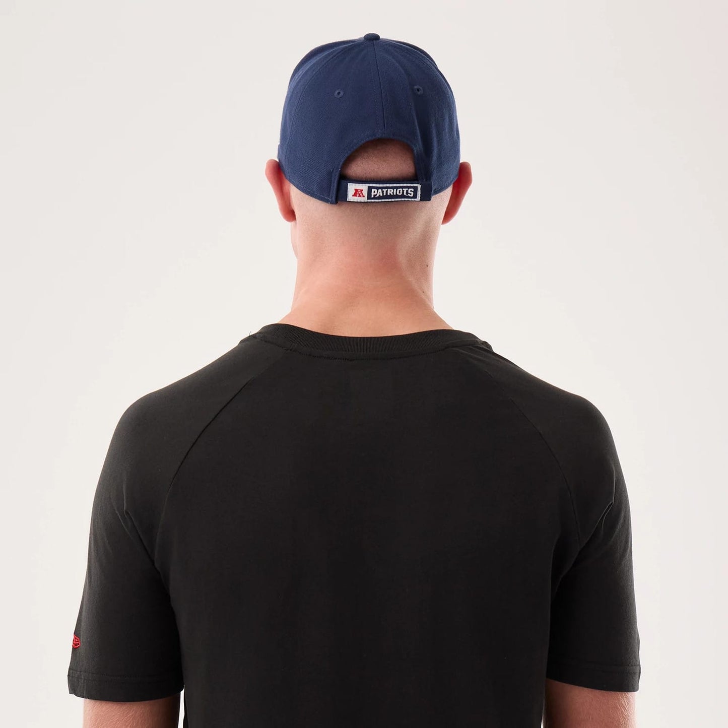 The model is wearing this NFL Sideline 2026 New England Patriots T-Shirt in black. 7