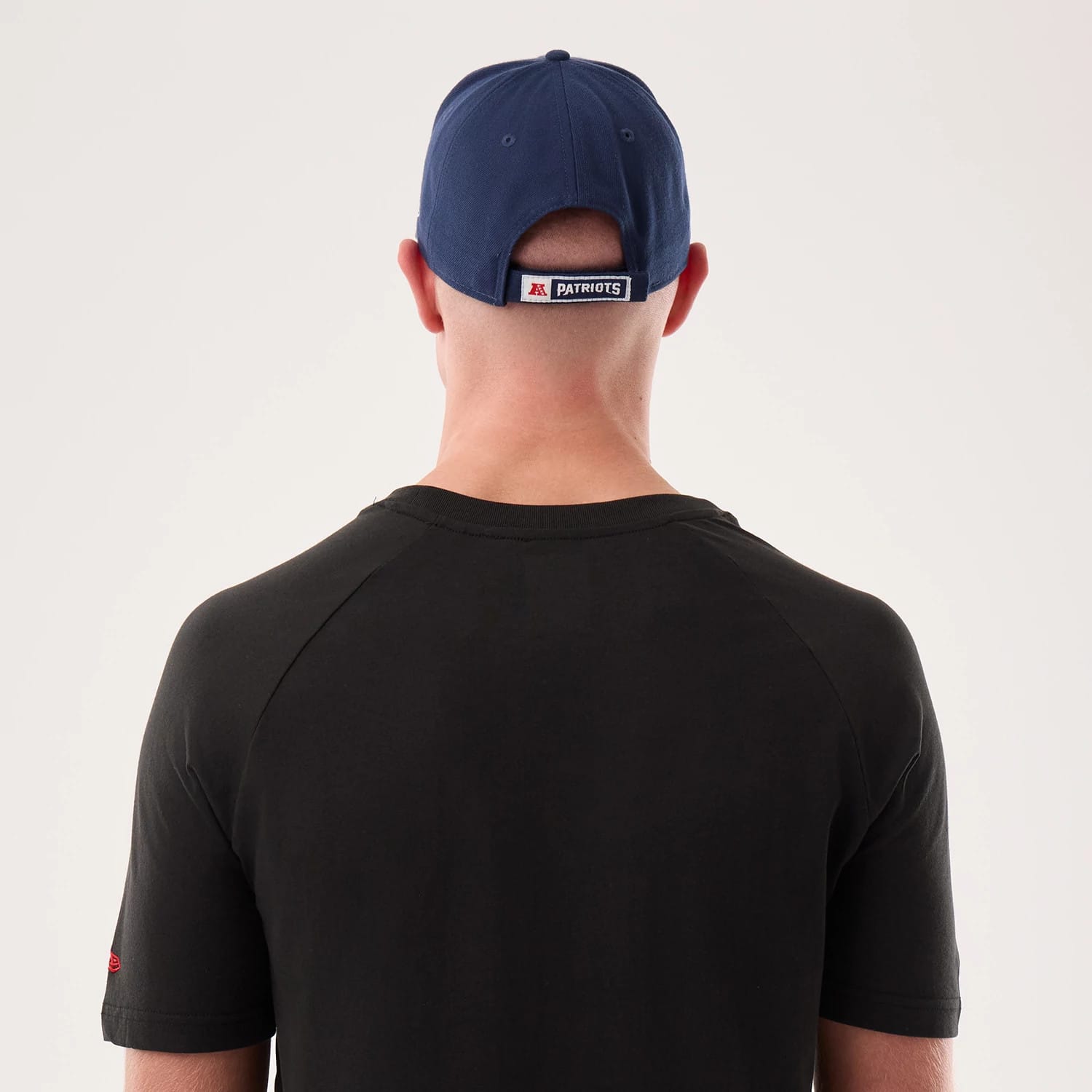 The model is wearing this NFL Sideline 2026 New England Patriots T-Shirt in black. 7