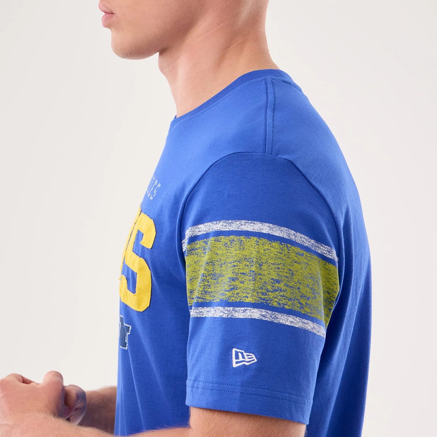 The model is wearing this NFL Sideline 2026 LA Rams T-Shirt in bright blue. 4