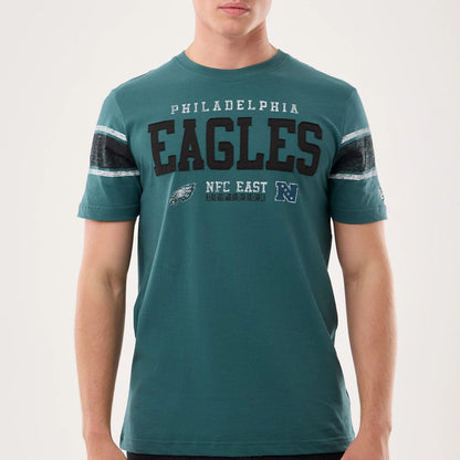 The model is wearing this NFL Sideline 2026 Philadelphia Eagles T-Shirt in dark green. 3