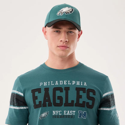 The model is wearing this NFL Sideline 2026 Philadelphia Eagles T-Shirt in dark green. 6