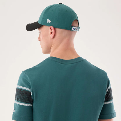 The model is wearing this NFL Sideline 2026 Philadelphia Eagles T-Shirt in dark green. 7