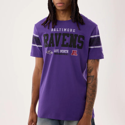 The model is wearing this NFL Sideline 2026 Baltimore Ravens T-Shirt in purple. 3