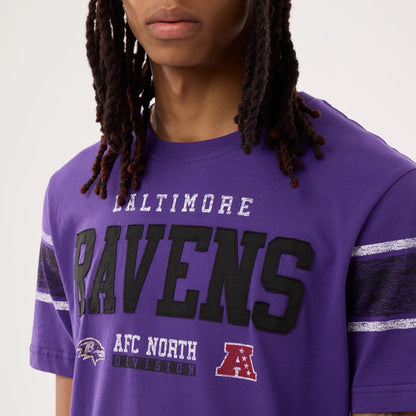 The model is wearing this NFL Sideline 2026 Baltimore Ravens T-Shirt in purple. 4