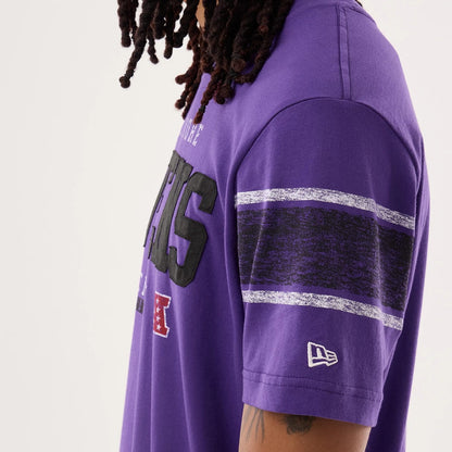 The model is wearing this NFL Sideline 2026 Baltimore Ravens T-Shirt in purple. 5