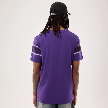 The model is wearing this NFL Sideline 2026 Baltimore Ravens T-Shirt in purple. 2