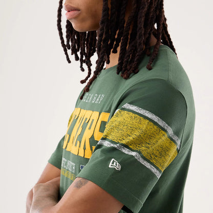 The model is wearing this NFL Sideline 2026 Green Bay Packers T-Shirt in dark green. 5