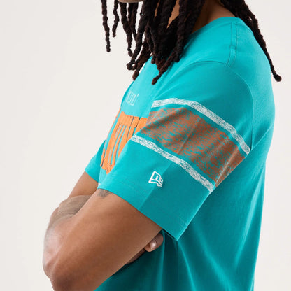 The model is wearing this NFL Sideline 2026 Miami Dolphins T-Shirt in turquoise. 5
