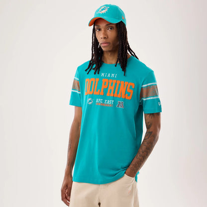 The model is wearing this NFL Sideline 2026 Miami Dolphins T-Shirt in turquoise. 1