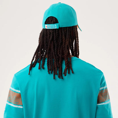 The model is wearing this NFL Sideline 2026 Miami Dolphins T-Shirt in turquoise. 7