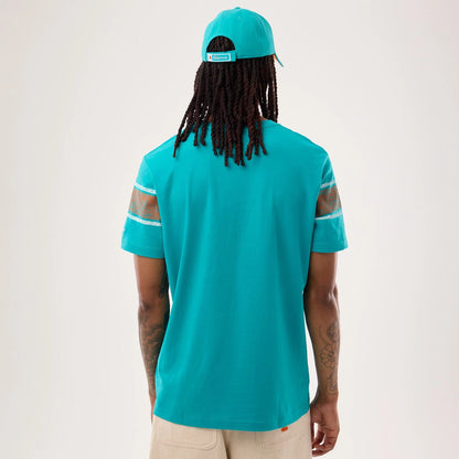 The model is wearing this NFL Sideline 2026 Miami Dolphins T-Shirt in turquoise. 2