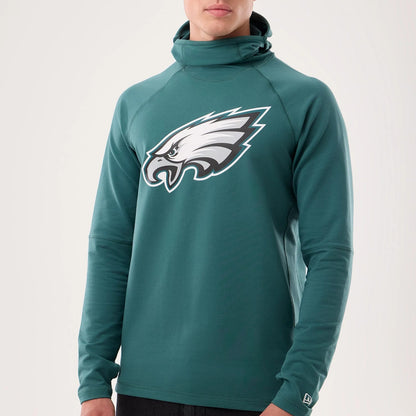 The model is wearing this NFL Sideline 2026 Philadelphia Eagles Balaclava Hoodie in dark green. 4