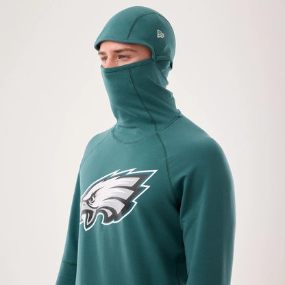 The model is wearing this NFL Sideline 2026 Philadelphia Eagles Balaclava Hoodie in dark green. 3
