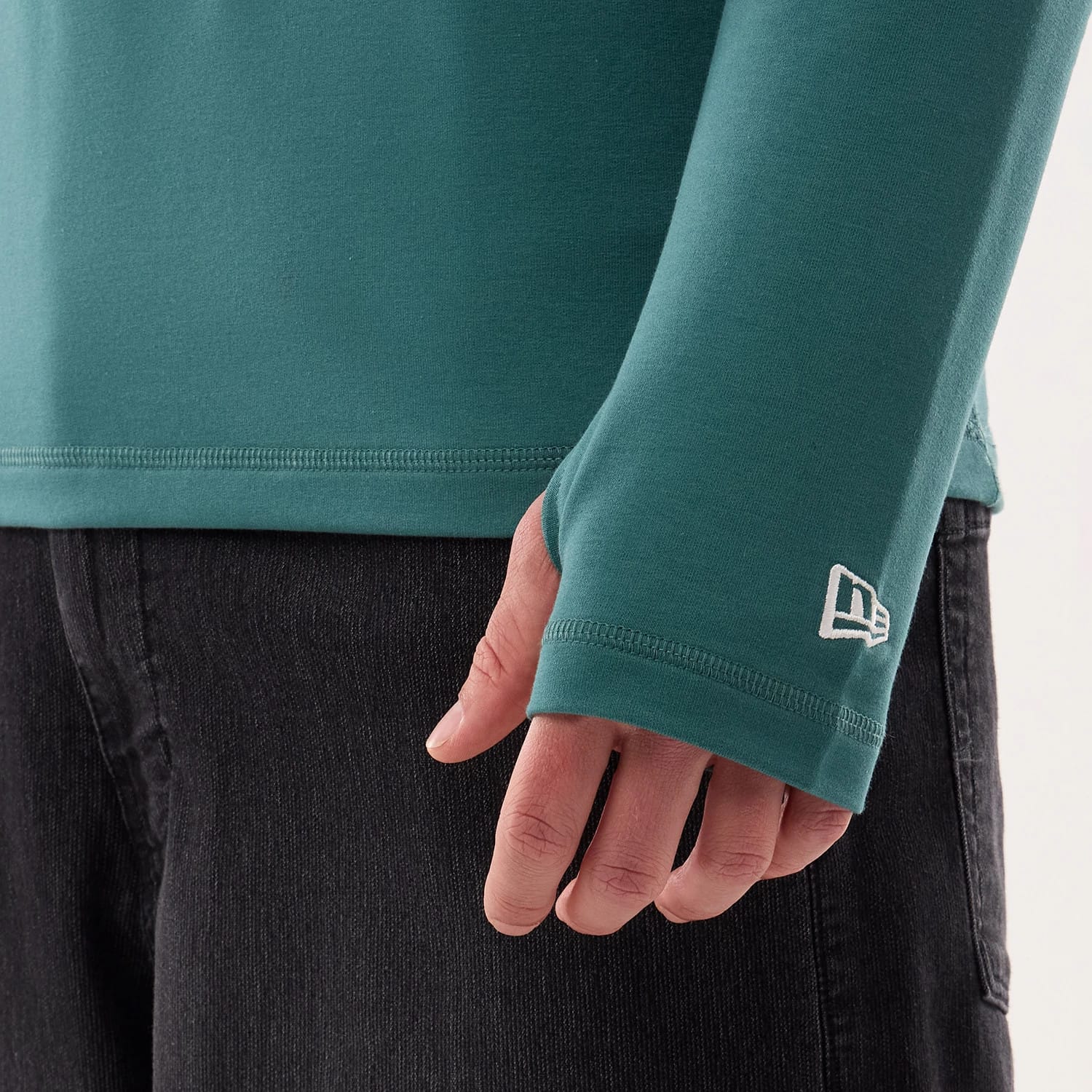 The model is wearing this NFL Sideline 2026 Philadelphia Eagles Balaclava Hoodie in dark green. 5