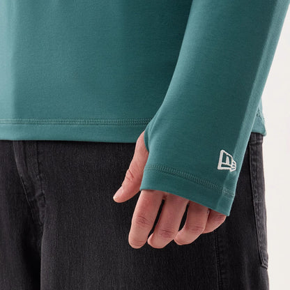 The model is wearing this NFL Sideline 2026 Philadelphia Eagles Balaclava Hoodie in dark green. 5