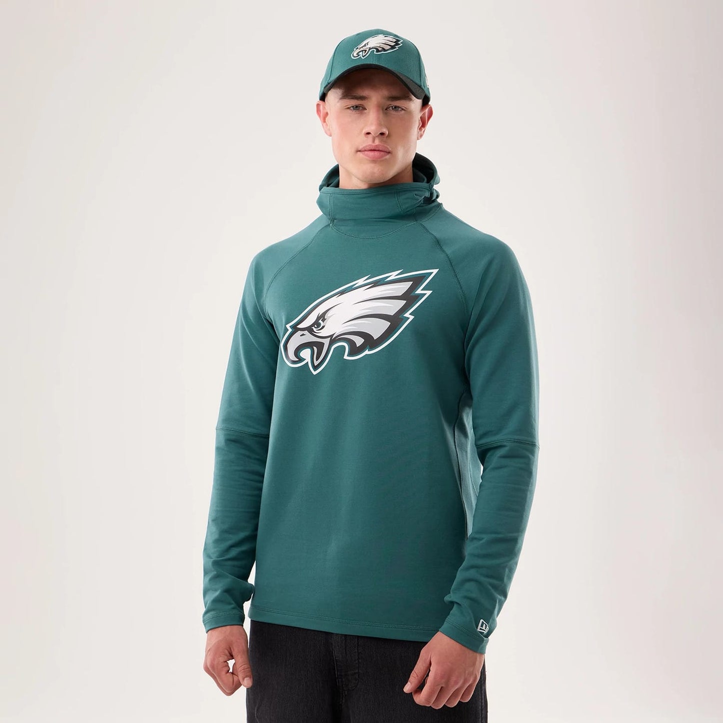 The model is wearing this NFL Sideline 2026 Philadelphia Eagles Balaclava Hoodie in dark green. 1