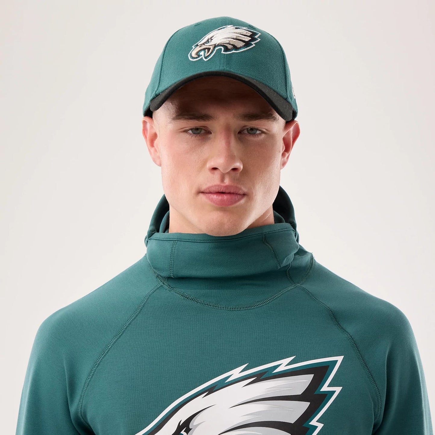 The model is wearing this NFL Sideline 2026 Philadelphia Eagles Balaclava Hoodie in dark green. 6