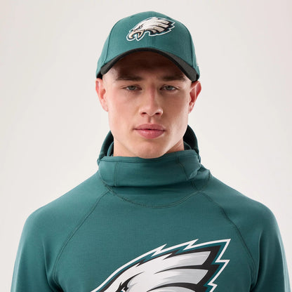 The model is wearing this NFL Sideline 2026 Philadelphia Eagles Balaclava Hoodie in dark green. 6