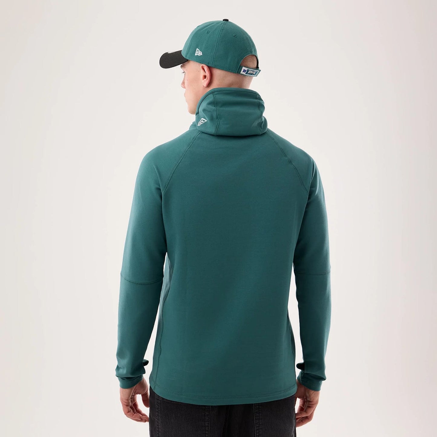 The model is wearing this NFL Sideline 2026 Philadelphia Eagles Balaclava Hoodie in dark green. 2