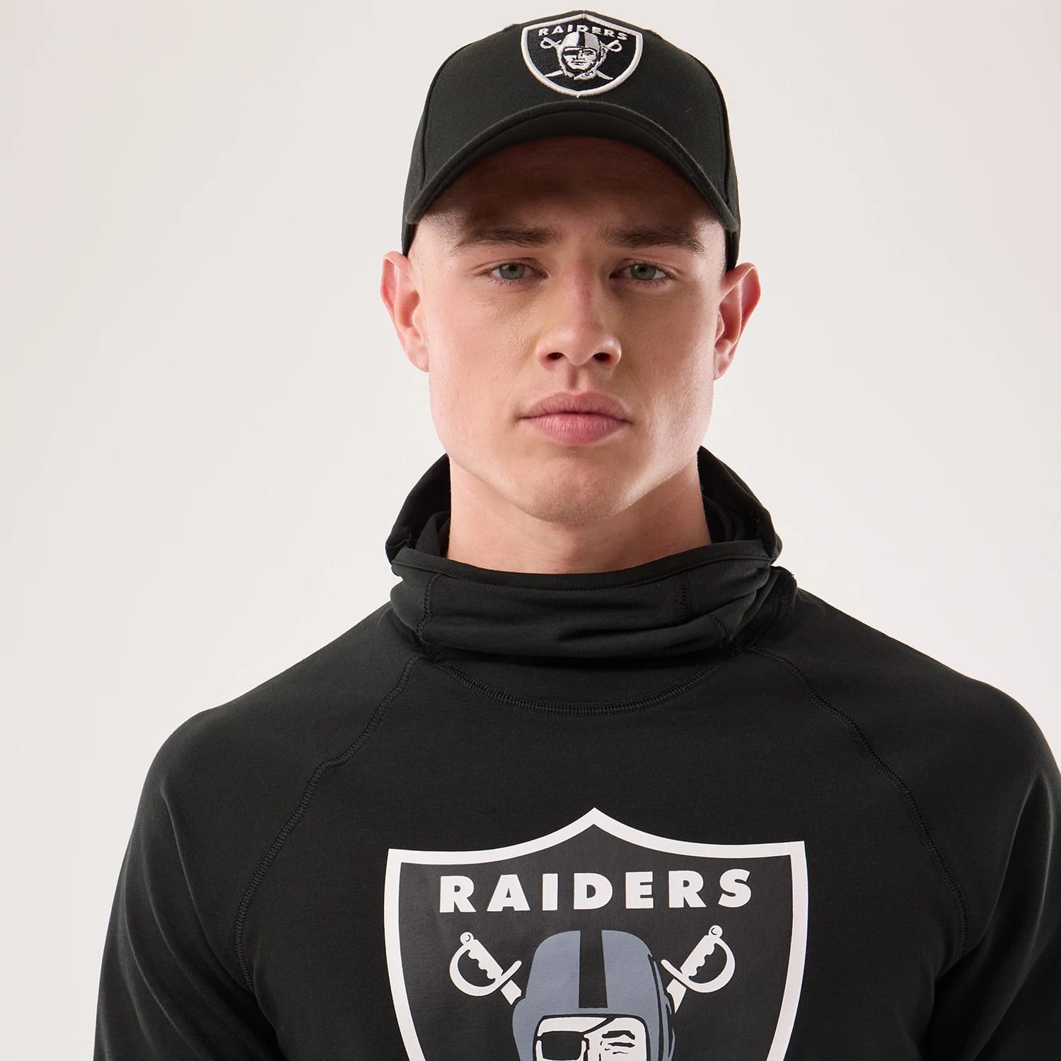 The model is wearing this NFL Sideline 2026 Las Vegas Raiders Balaclava Hoodie in black. 6