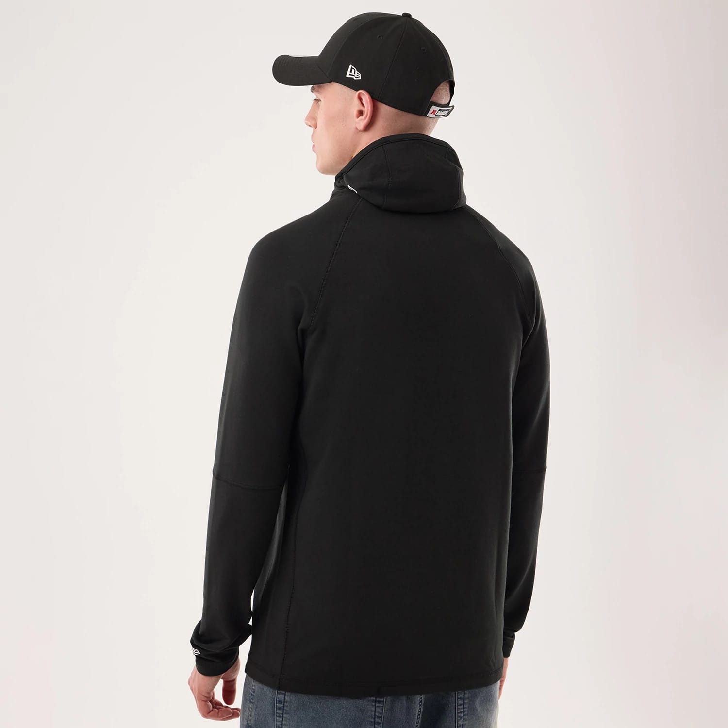 The model is wearing this NFL Sideline 2026 Las Vegas Raiders Balaclava Hoodie in black. 2