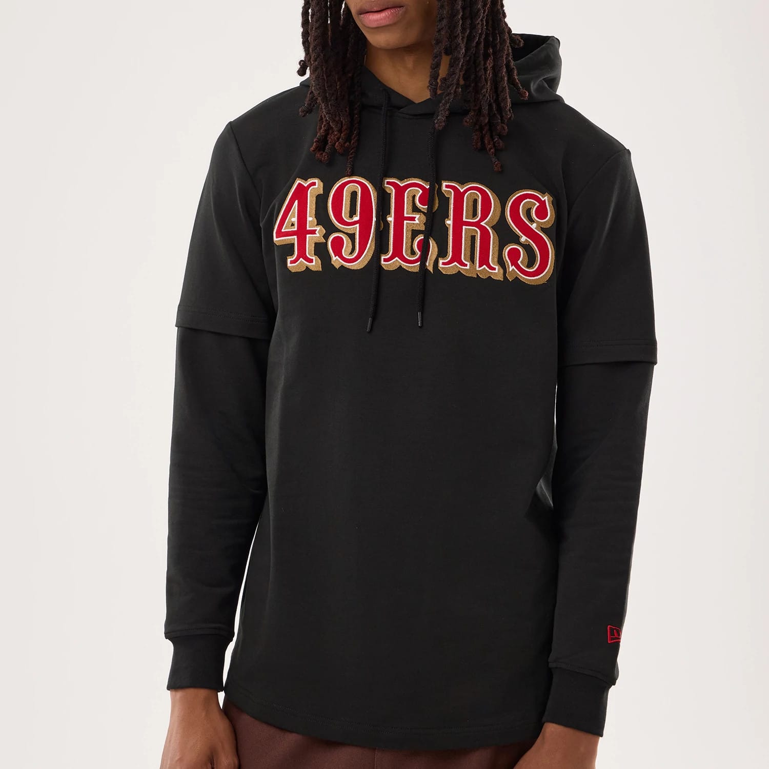 The model is wearing this NFL Sideline 2026 San Francisco 49ers Double Sleeve Hoodie in black. 4
