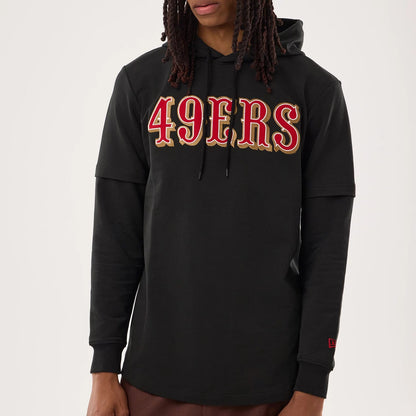 The model is wearing this NFL Sideline 2026 San Francisco 49ers Double Sleeve Hoodie in black. 4