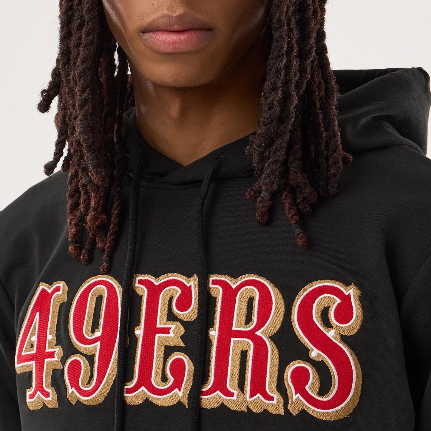 The model is wearing this NFL Sideline 2026 San Francisco 49ers Double Sleeve Hoodie in black. 3