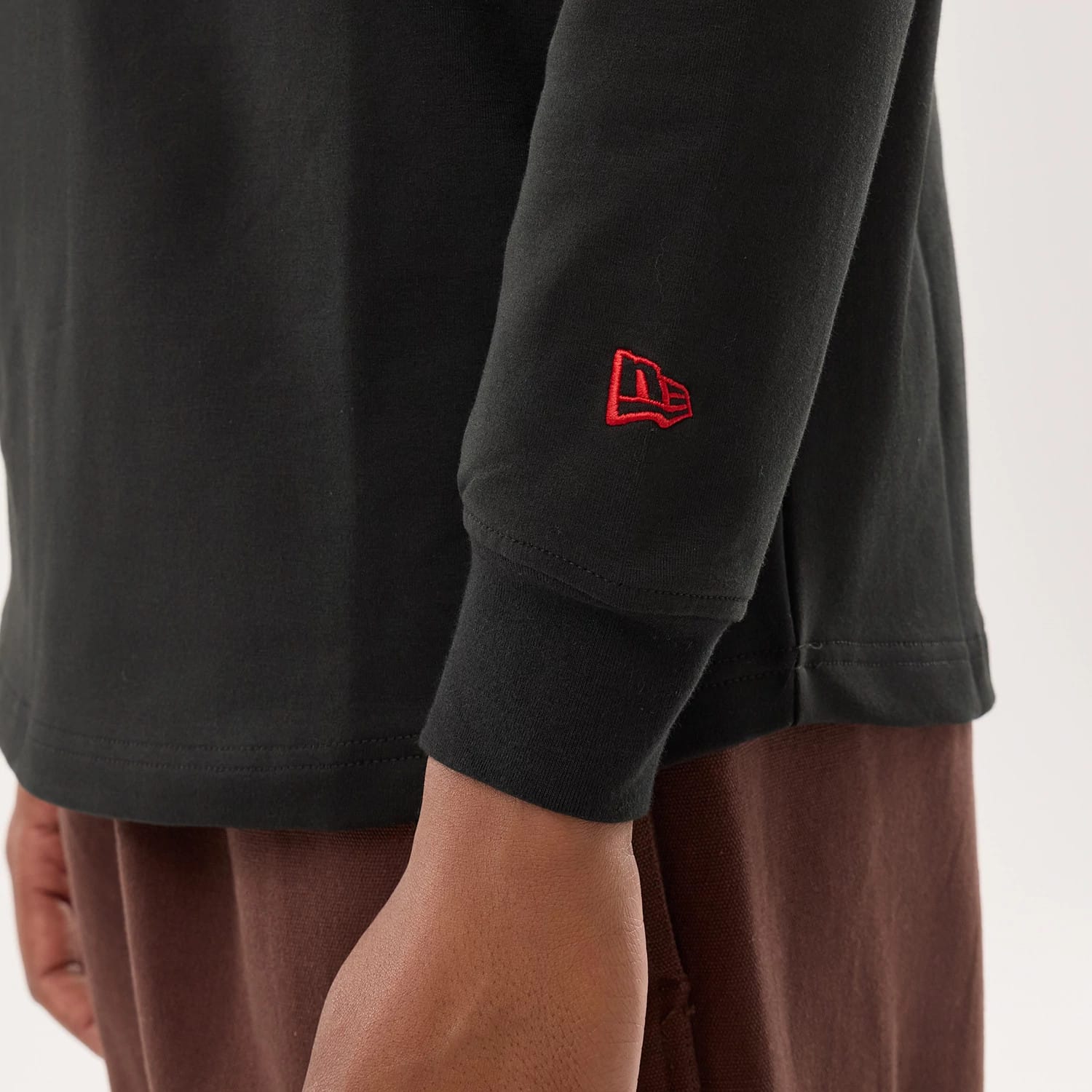 The model is wearing this NFL Sideline 2026 San Francisco 49ers Double Sleeve Hoodie in black. 5