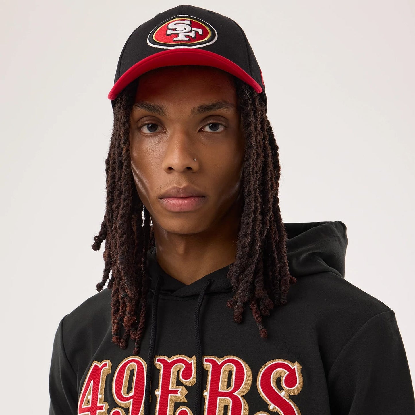 The model is wearing this NFL Sideline 2026 San Francisco 49ers Double Sleeve Hoodie in black. 7