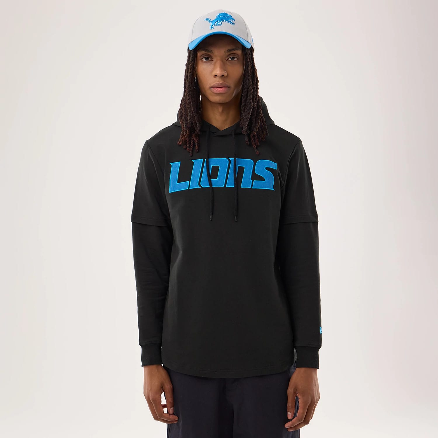 The model is wearing this NFL Sideline 2026 Detroit Lions Double Sleeve Hoodie in black. 1