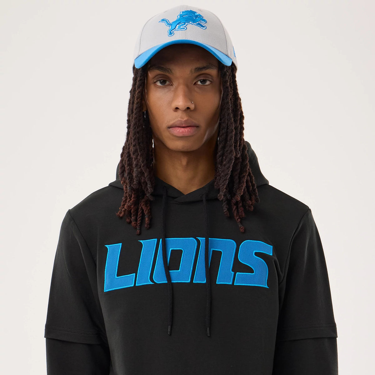 The model is wearing this NFL Sideline 2026 Detroit Lions Double Sleeve Hoodie in black. 6