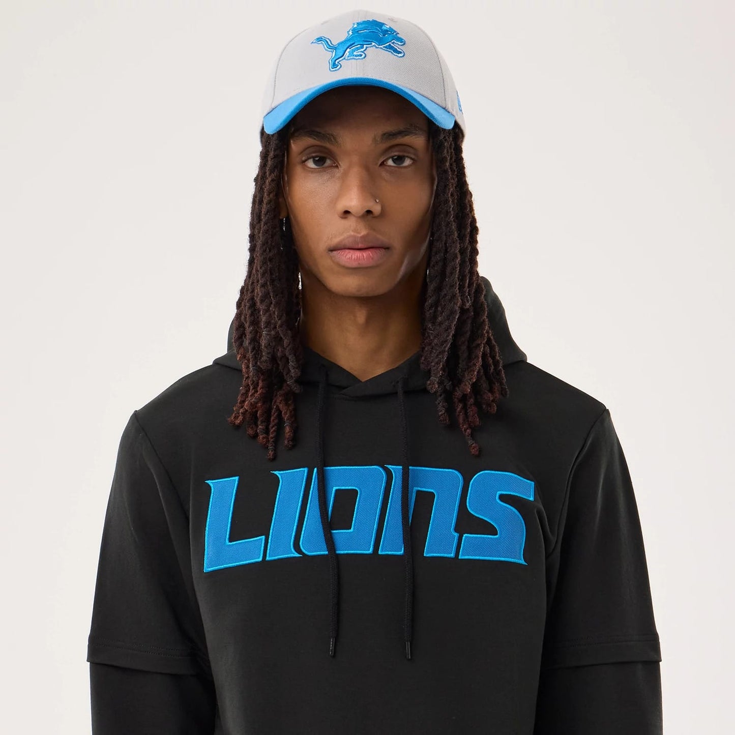 The model is wearing this NFL Sideline 2026 Detroit Lions Double Sleeve Hoodie in black. 6