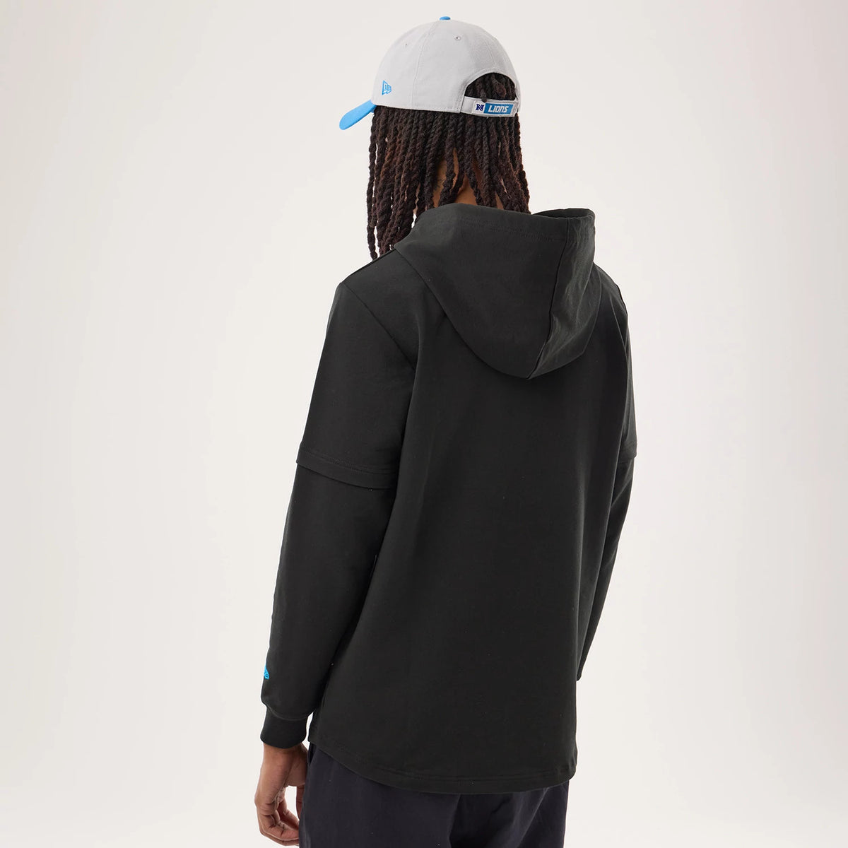 The model is wearing this NFL Sideline 2026 Detroit Lions Double Sleeve Hoodie in black. 2