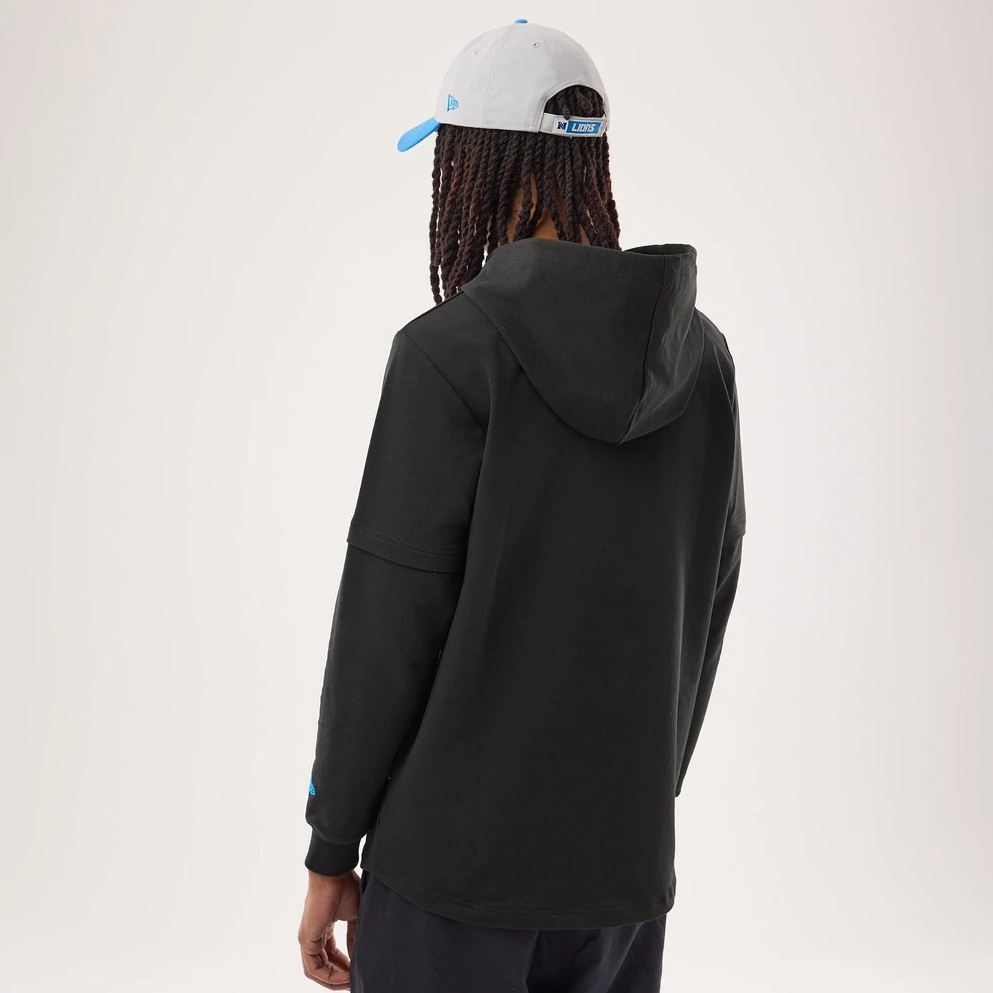 The model is wearing this NFL Sideline 2026 Detroit Lions Double Sleeve Hoodie in black. 2