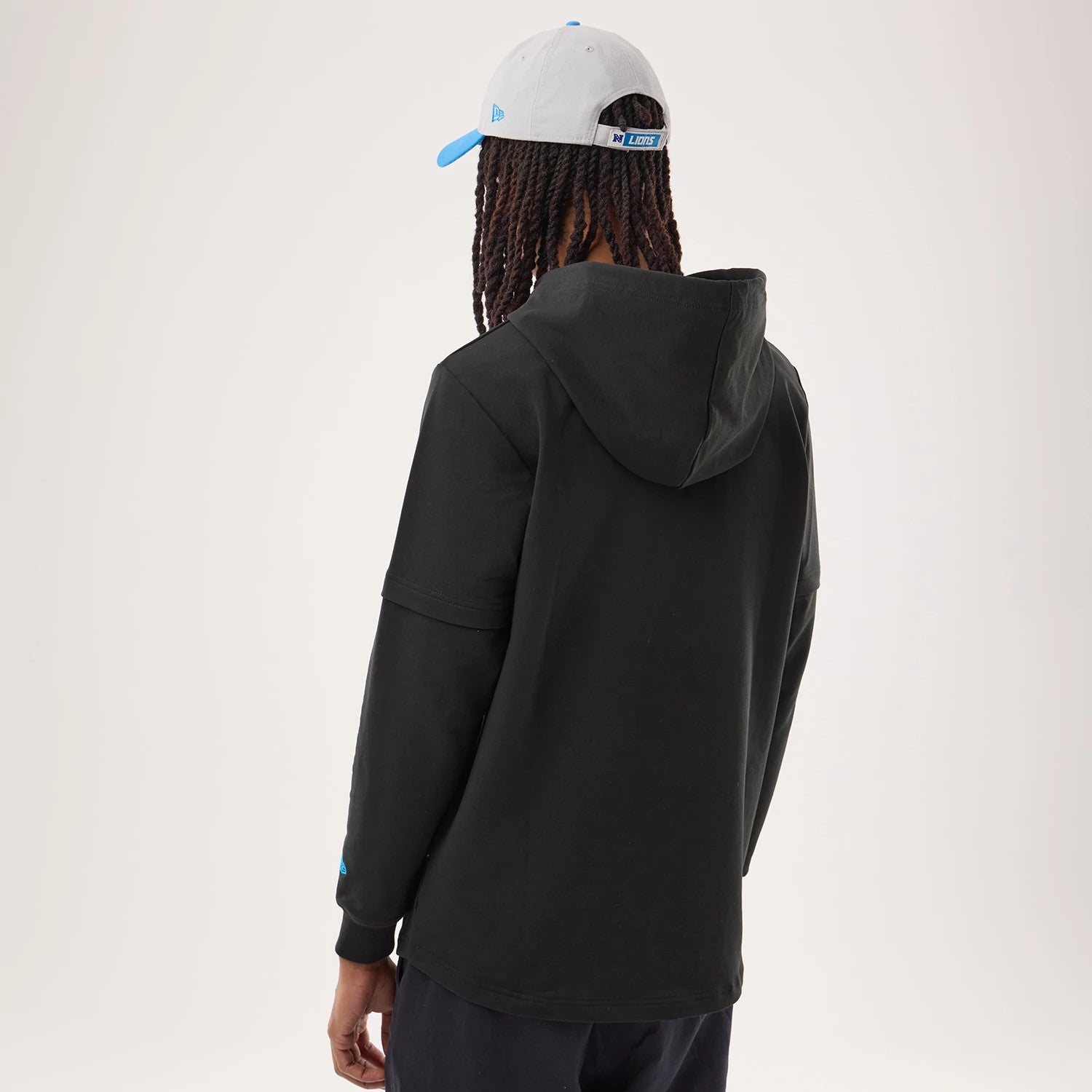 The model is wearing this NFL Sideline 2026 Detroit Lions Double Sleeve Hoodie in black. 2