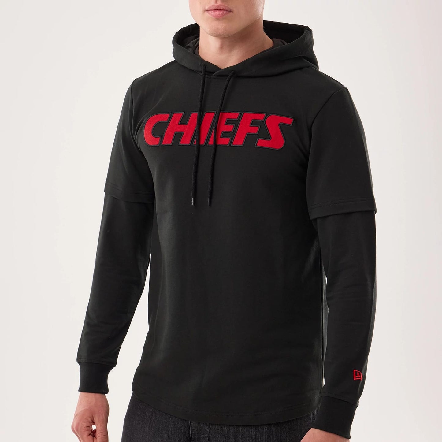 The model is wearing this NFL Sideline 2026 Kansas City Chiefs Double Sleeve Hoodie in black. 3