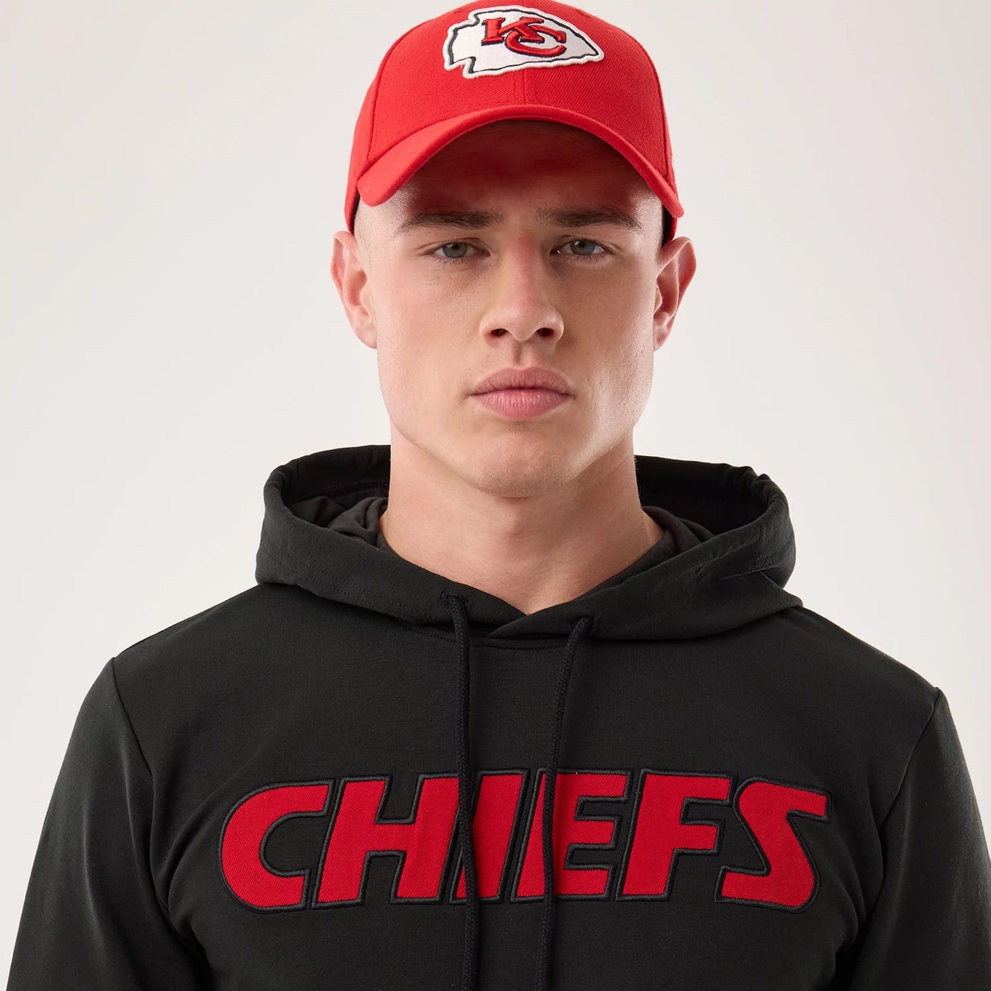 The model is wearing this NFL Sideline 2026 Kansas City Chiefs Double Sleeve Hoodie in black. 6