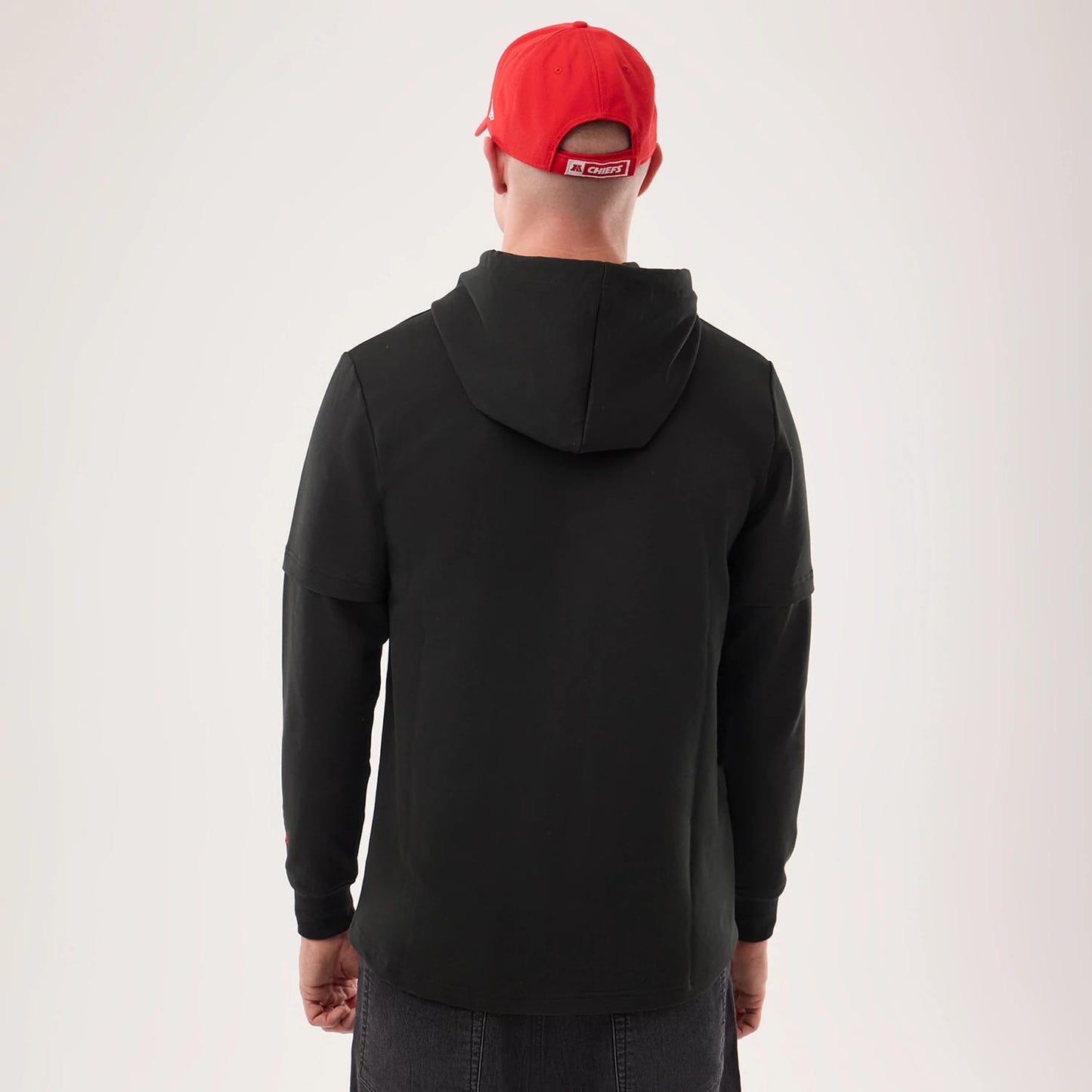 The model is wearing this NFL Sideline 2026 Kansas City Chiefs Double Sleeve Hoodie in black. 2