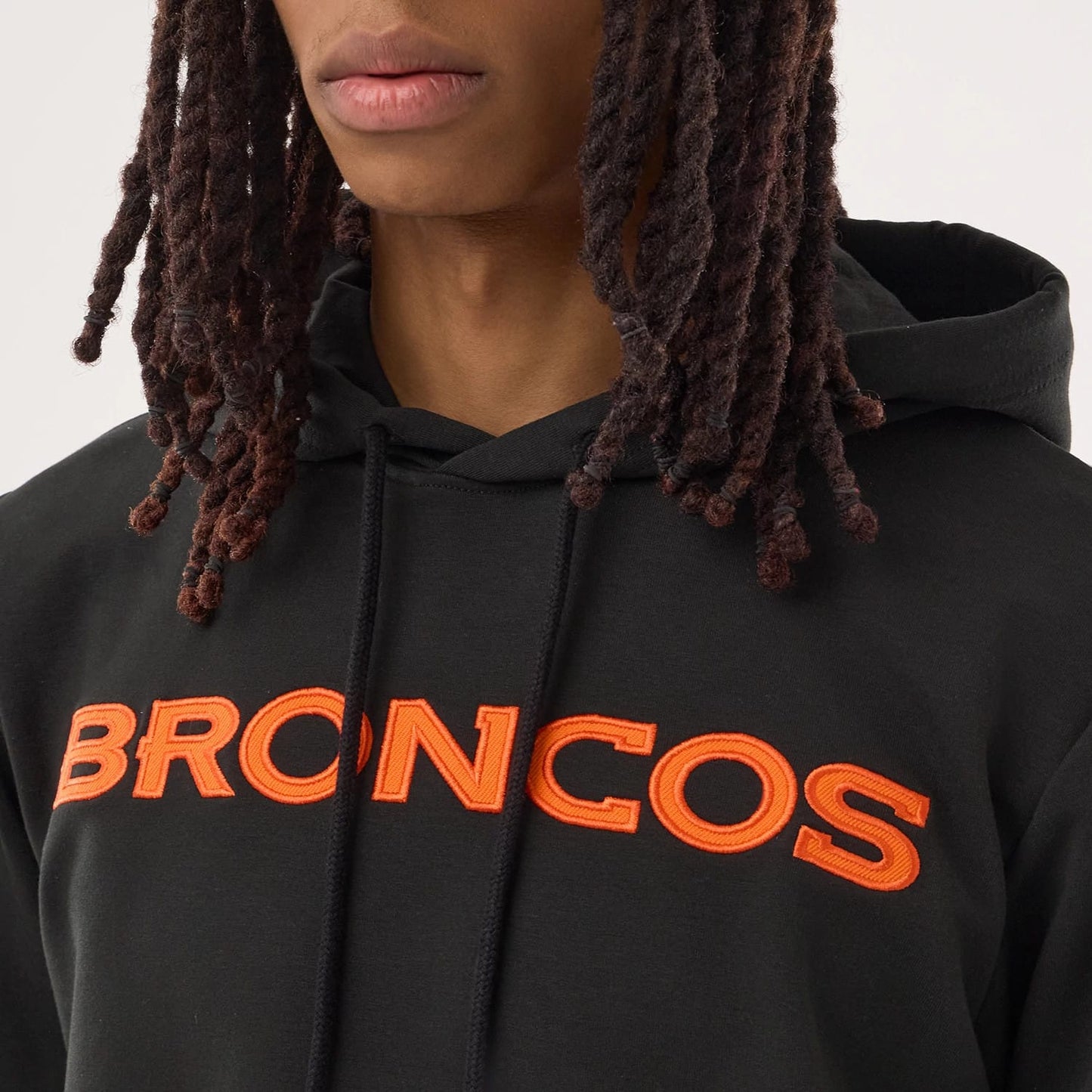 The model is wearing this NFL Sideline 2026 Denver Broncos Double Sleeve Hoodie in black. 3