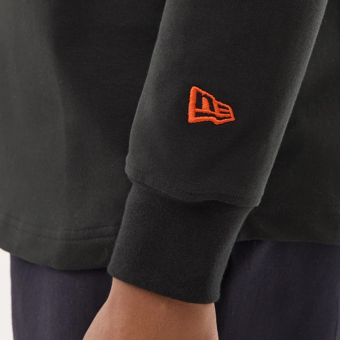 The model is wearing this NFL Sideline 2026 Denver Broncos Double Sleeve Hoodie in black. 5