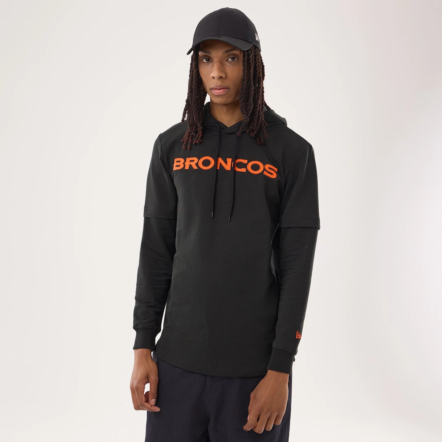 The model is wearing this NFL Sideline 2026 Denver Broncos Double Sleeve Hoodie in black. 1